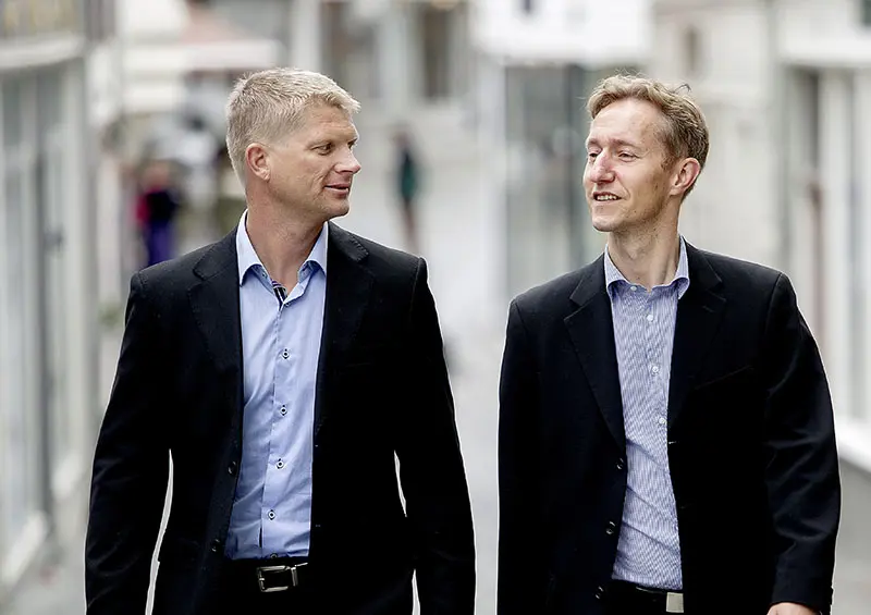 Two men walking along the street