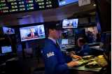 Man in front of screen at stock exchange