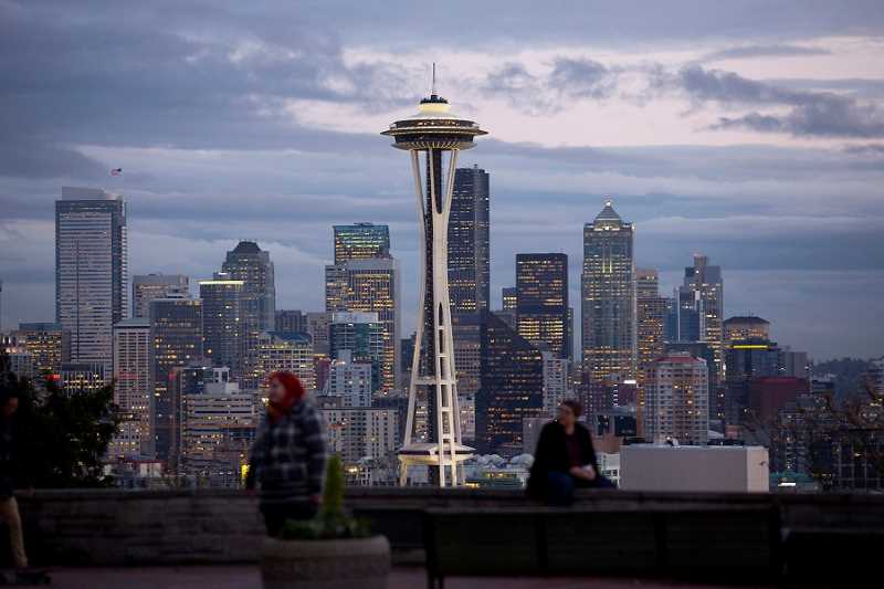 Two people in front of a cityscape