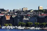 Picture of boats on water with cityscape behind